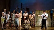 Cody Jamison Strand as Elder Cunningham and the cast of The Book of Mormon
